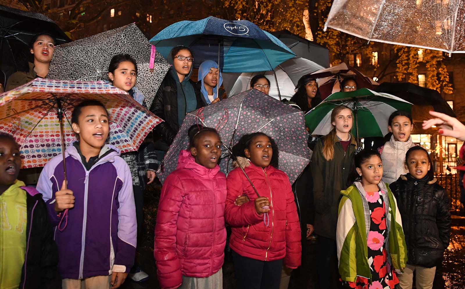 group singing with umbrellas